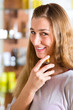 woman buying perfume in shop or store