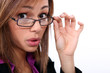 bespectacled woman knitting her brows