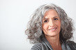 Grey-haired woman on white background