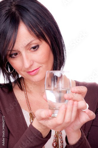 Photo: Woman and half full glass of water Woman and half full glass of water