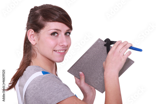 Photo: Woman cutting a tile Woman cutting a tile