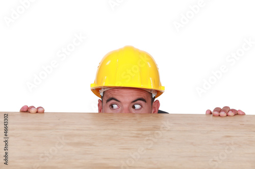 Photo: Entrepreneur hiding behind a table Entrepreneur hiding behind a table