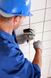 Electrician screwing plug