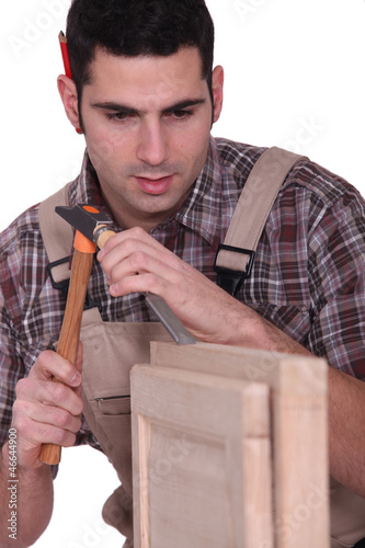 Photo: Man using hammer and chisel Man using hammer and chisel