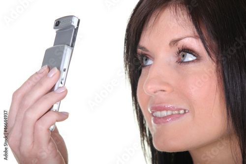 Photo: Woman taking picture with mobile phone Woman taking picture with mobile phone