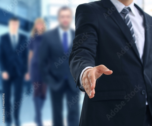 Photo: A business man with an open hand ready to seal a deal A business man with an open hand ready to seal a deal