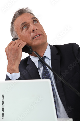 Photo: Senior businessman working at desk Senior businessman working at desk