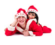 Happy young couple wearing santa claus clothes