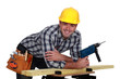 Carpenter posing with power drill