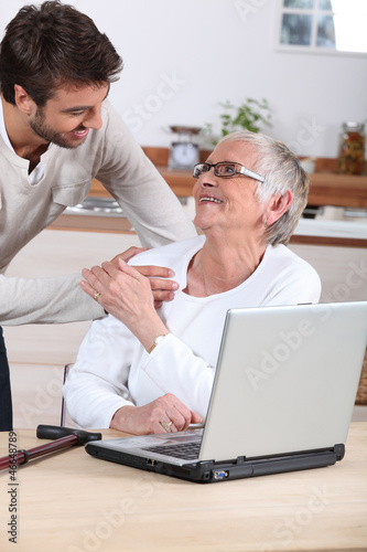 Photo: man explaining to senior woman how to use computer man explaining to senior woman how to use computer