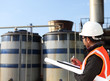 engineer write on notepad with large industry background