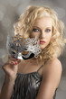 blonde girl with silver mask turned of three quarters