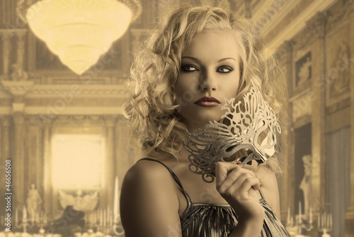 Photo: blonde girl with silver mask looks at right blonde girl with silver mask looks at right