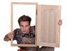craftsman looking through a window frame