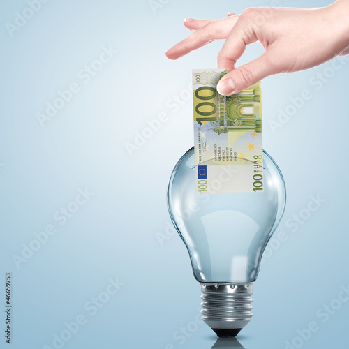 Photo: Money inside an electric light bulb Money inside an electric light bulb