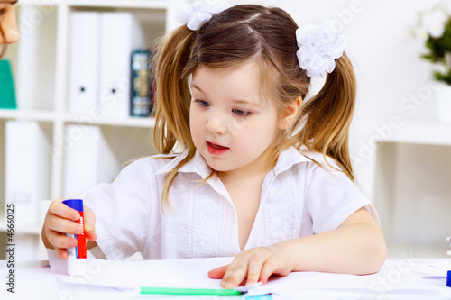 Photo: Little girl and her mother studying Little girl and her mother studying