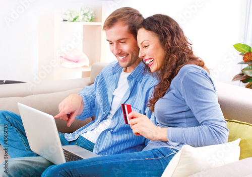 Photo: Online Shopping. Couple Using Credit Card to Internet Shop Online Shopping. Couple Using Credit Card to Internet Shop