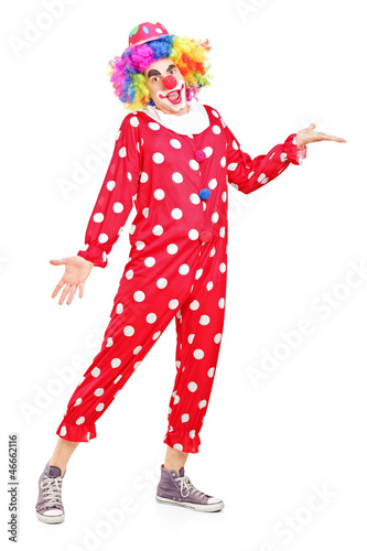 Photo: Full length portrait of a smiling happy clown gesturing Full length portrait of a smiling happy clown gesturing