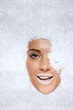 Laughing woman appearing through snow
