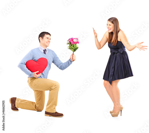 Photo: Male on knee giving a bouquet of flowers to his girlfriend Male on knee giving a bouquet of flowers to his girlfriend
