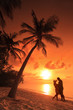 Photo: Couple kissing at beach with sunset in the background, Maldives Couple kissing at beach with sunset in the background, Maldives