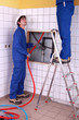 Two plumber fixing bathroom water supply
