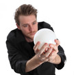 Man looking into a glass ball