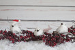 Photo: Three Faux White birds, berries, a santa hat and snow Three Faux White birds, berries, a santa hat and snow