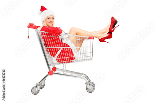 Photo: Smiling female wearing christmas costume posing in a shopping ca Smiling female wearing christmas costume posing in a shopping ca