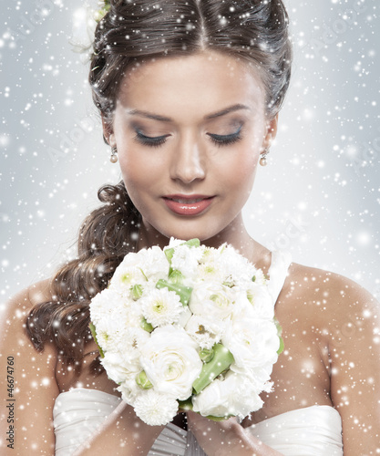 Photo: Portrait of a young bride holding a bouquet of flowers Portrait of a young bride holding a bouquet of flowers
