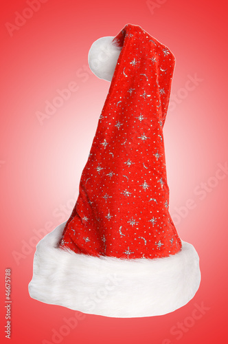Photo: Santa Hat over a red background Santa Hat over a red background
