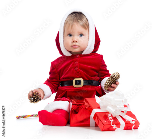 Photo: Santa Claus baby girl with gift box isolated on white background Santa Claus baby girl with gift box isolated on white background