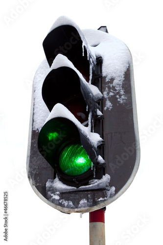 Photo: Traffic light in the snow. White background. Traffic light in the snow. White background.