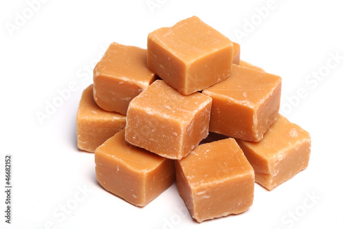 Photo: Tasty brown butterscotch on a white background Tasty brown butterscotch on a white background
