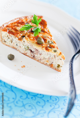 Photo: Quiche with tuna and capers. Selective focus Quiche with tuna and capers. Selective focus