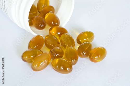 Photo: Rice bran oil pills pouring from the bottle Rice bran oil pills pouring from the bottle
