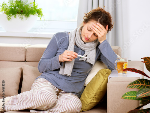Photo: Sick Woman with Thermometer. Headache. Flu Sick Woman with Thermometer. Headache. Flu