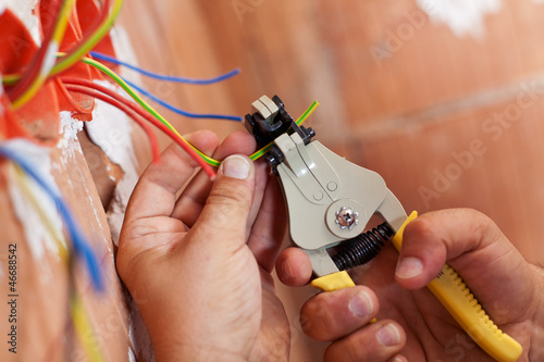 Photo: Electrician peeling off wires Electrician peeling off wires