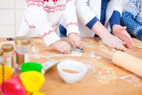 Photo: Close up of family baking Close up of family baking