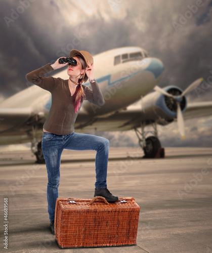 Photo: The traveler on the airport against old passenger plane. The traveler on the airport against old passenger plane.