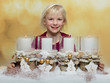 Cute blond child with Advent wreath waiting for christmas