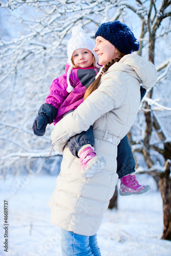 Photo: Mother and daughter outdoors on winter day Mother and daughter outdoors on winter day