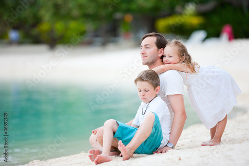 Photo: Father and kids on a beach Father and kids on a beach
