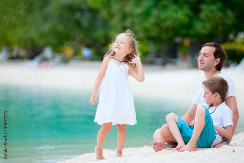 Photo: Father and kids on a beach Father and kids on a beach