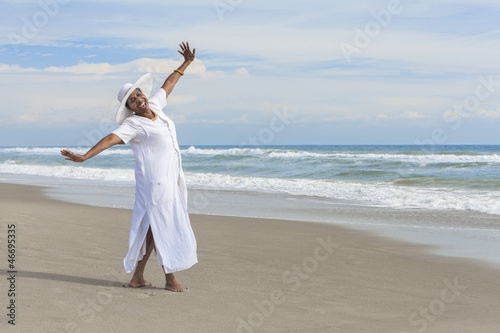 Photo: Happy African American Woman Dancing on Beach Happy African American Woman Dancing on Beach