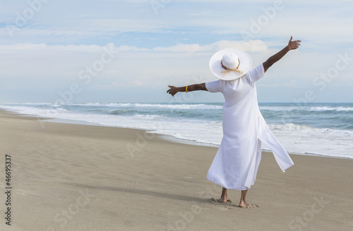 Photo: Happy African American Woman Dancing on Beach Happy African American Woman Dancing on Beach