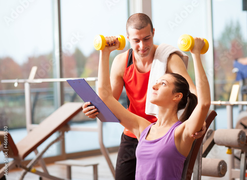 Photo: Woman working out in a fitness club Woman working out in a fitness club