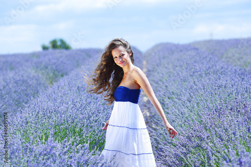 Photo: Woman standing on a lavender field Woman standing on a lavender field