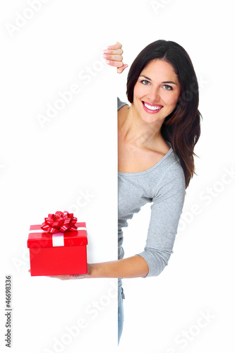 Photo: Beautiful young Christmas girl with a present. Beautiful young Christmas girl with a present.