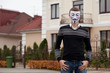 hacker in masked members of Anonymous posing